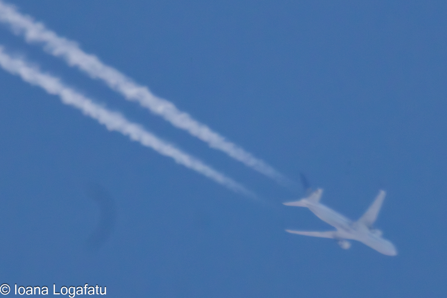Airplane soaring through the clear blue sky